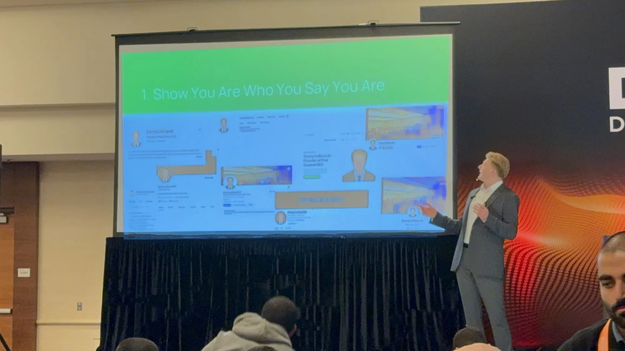 Dan Leibrandt on stage at a marketing conference, presenting a slide titled Show You Are Who You Say You Are